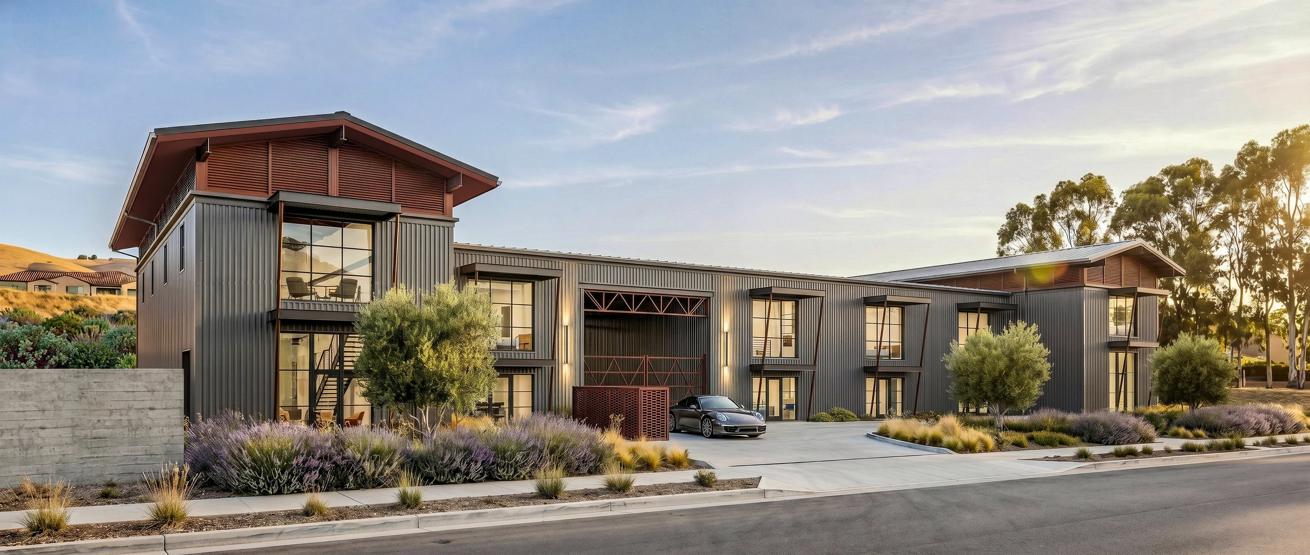 Daylight visualization of AutoLofts, with automobile storage, upper lofts, and a landscaped arrival court.